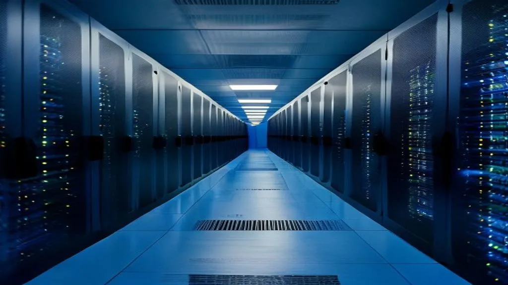 Rows of on-premise servers in a data centre lit with magenta light